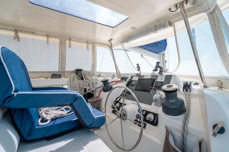Slide: The Image of Interior of a 2013 Leopard 48 yacht cockpit with steering wheel and navigation equipment. - 42