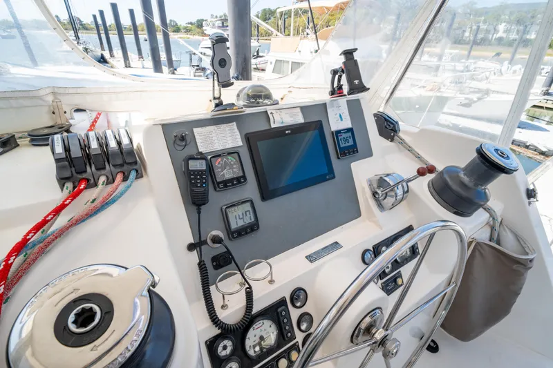 Slide: The Image of Cockpit of a 2013 Leopard 48 yacht with navigation instruments and steering wheel. - 44