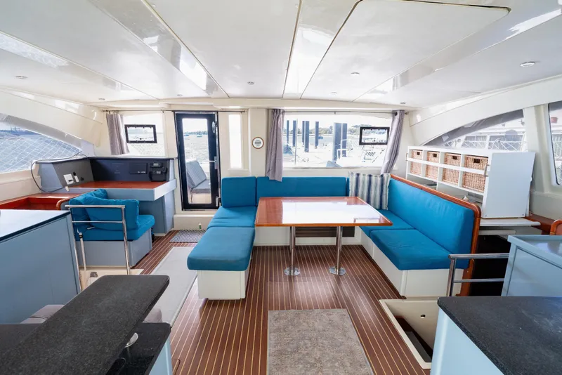 Slide: The Image of Luxurious interior of a 2013 Leopard 48 yacht with modern seating and dining area. - 51