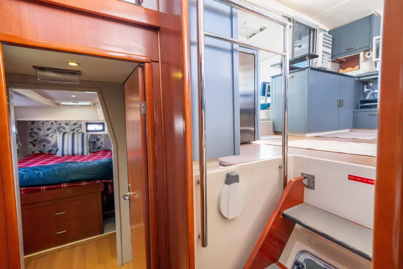 Slide: The Image of Interior of 2013 Leopard 48 yacht featuring bedroom and modern kitchen area. - 58