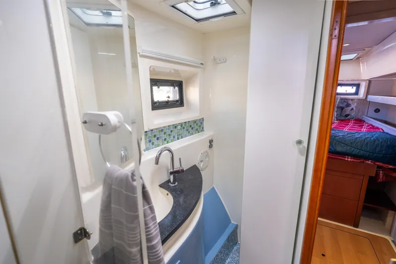 Slide: The Image of Bathroom interior of 2013 Leopard 48 yacht, featuring modern sink and cozy cabin view. - 61