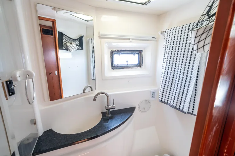Slide: The Image of Bathroom interior of 2013 Leopard 48 yacht with modern sink and window. - 62