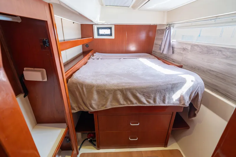 Slide: The Image of Cozy cabin interior of 2013 Leopard 48 yacht with wooden furnishings and bed. - 65