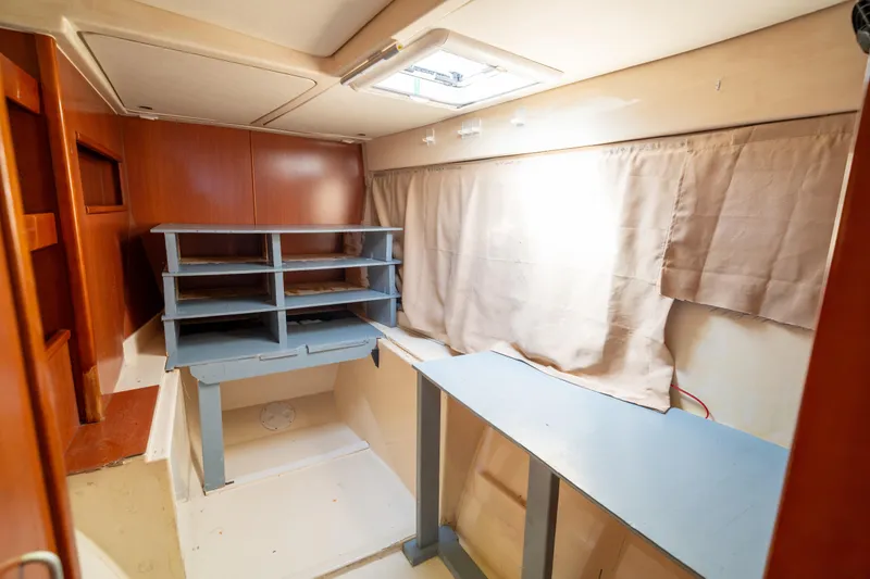 Slide: The Image of Interior of a 2013 Leopard 48 yacht with wooden cabinetry and shelving. - 67