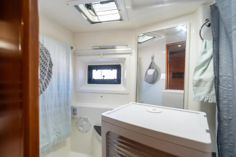Slide: The Image of Bathroom interior of 2013 Leopard 48 yacht, featuring window and mirror. - 69