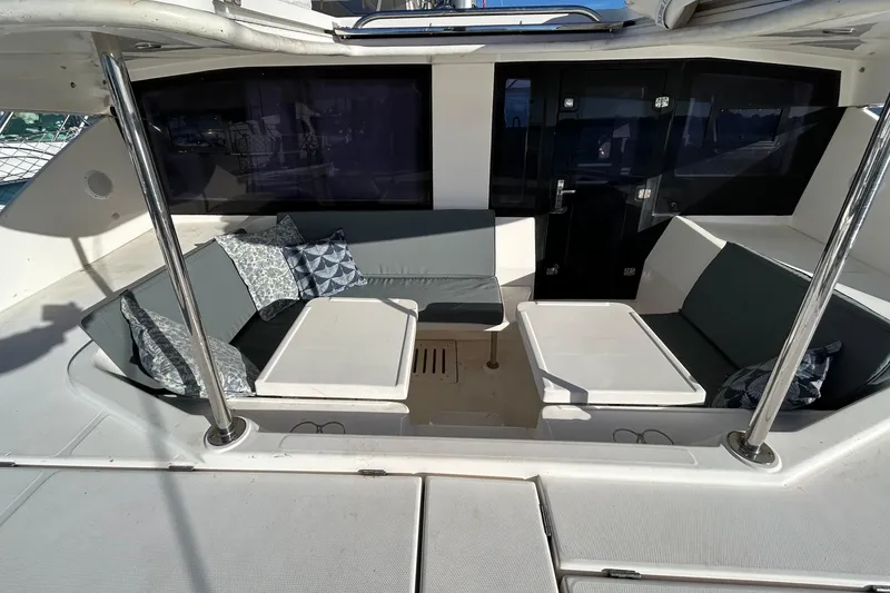 Slide: The Image of Luxurious 2013 Leopard 48 yacht interior with cushioned seating and tables. - 8