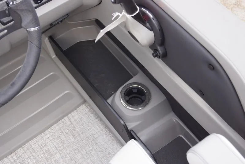 Slide: The Image of Interior of 2026 Avalon Catalina Versatile Rear Bench boat, featuring steering wheel and cup holder. - 18