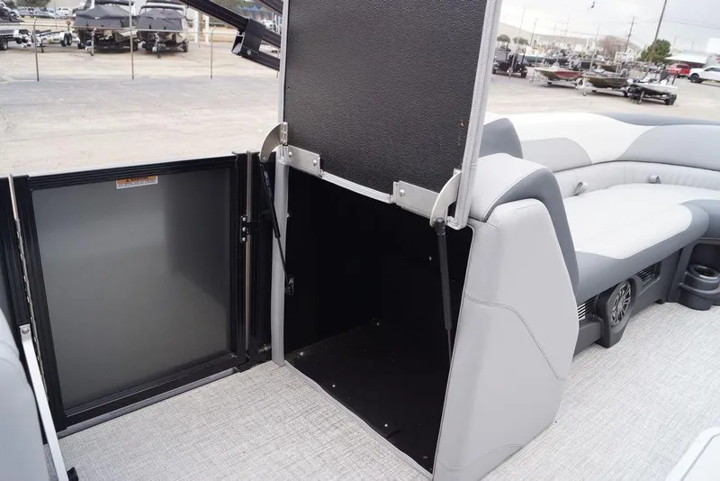 Slide: The Image of 2026 Avalon Catalina Versatile Rear Bench boat interior with open storage compartment. - 21