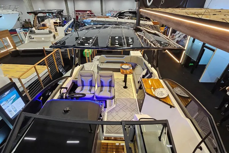 Slide: The Image of Luxurious Hanover 327 yacht interior, 2026 model, featuring modern seating and elegant design at a boat show. - 4