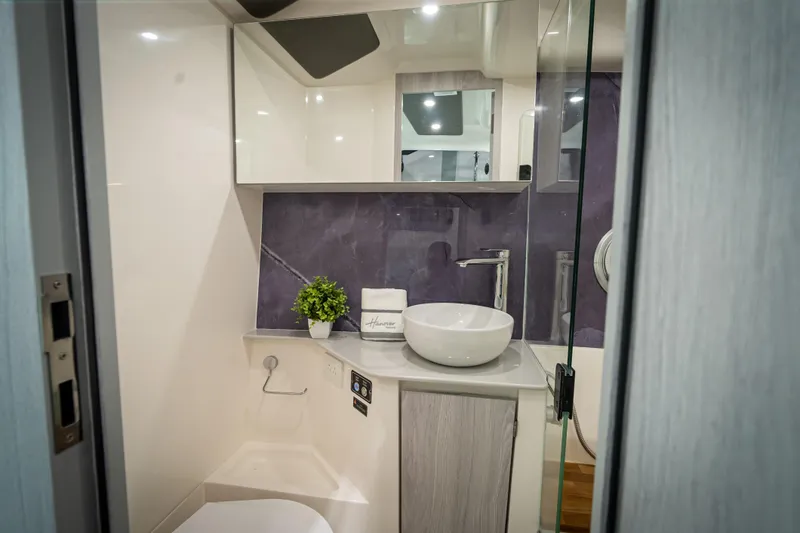 Slide: The Image of Modern bathroom in 2026 Hanover 347 RV with sleek design and vessel sink. - 20