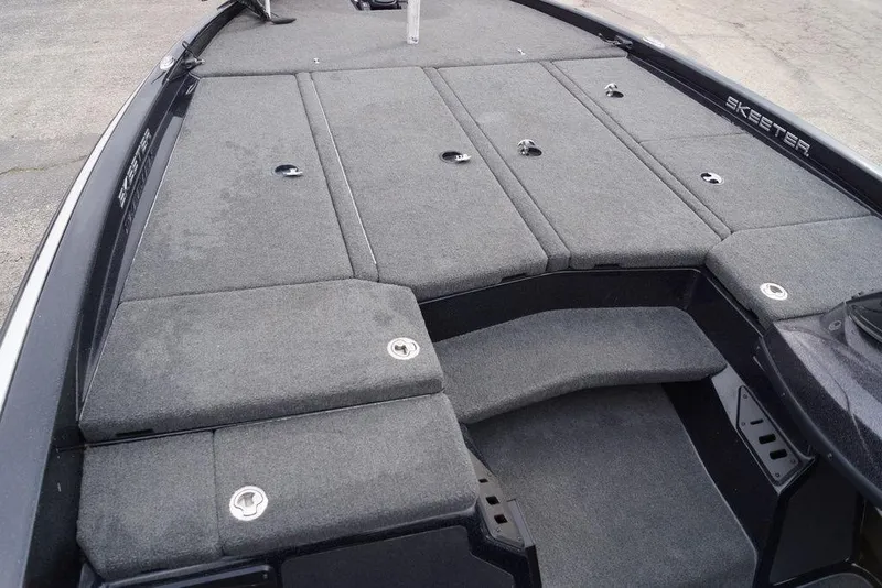 Slide: The Image of 2019 Skeeter ZX250 boat deck with gray carpet and storage compartments. - 13