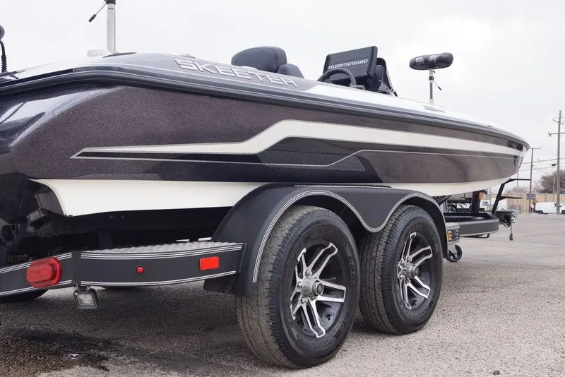Slide: The Image of 2019 Skeeter ZX250 boat on trailer, featuring dual wheels and sleek design. - 3
