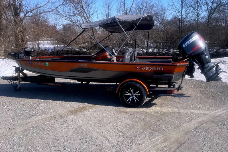 The Image of 2019 Vexus AVX1880 boat with Evinrude motor outdoors. - 1