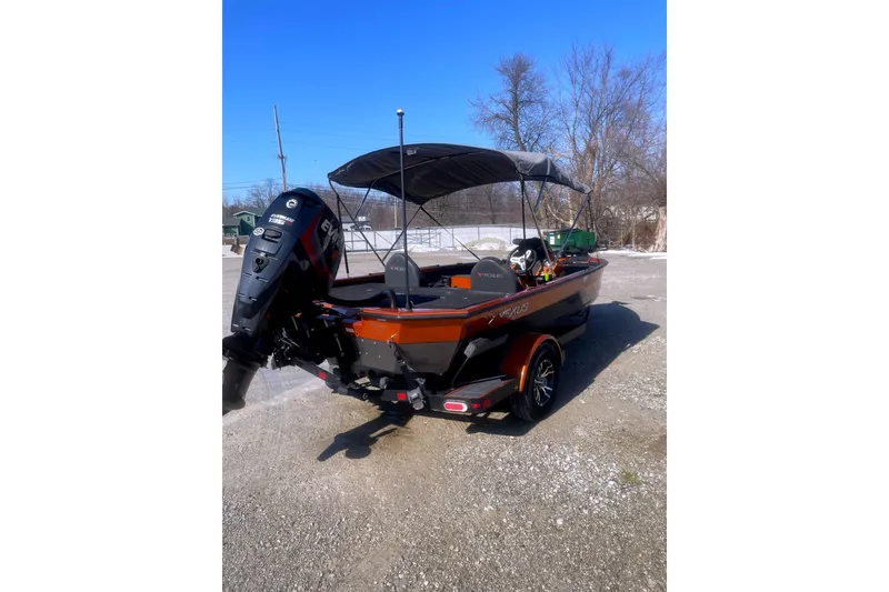 Slide: The Image of 2019 Vexus AVX1880 boat with outboard motor parked outdoors. - 3