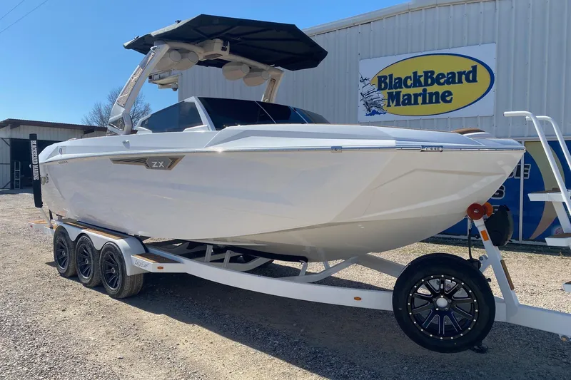 Slide: The Image of 2025 Tigé Ultré 25ZX boat on trailer at BlackBeard Marine dealership. - 1
