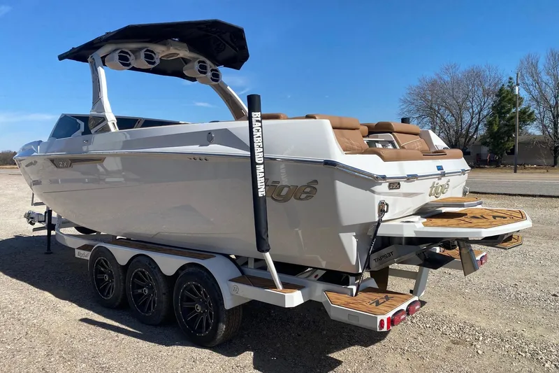 Slide: The Image of 2025 Tigé Ultré 25ZX boat on trailer, featuring sleek design and modern amenities. - 4