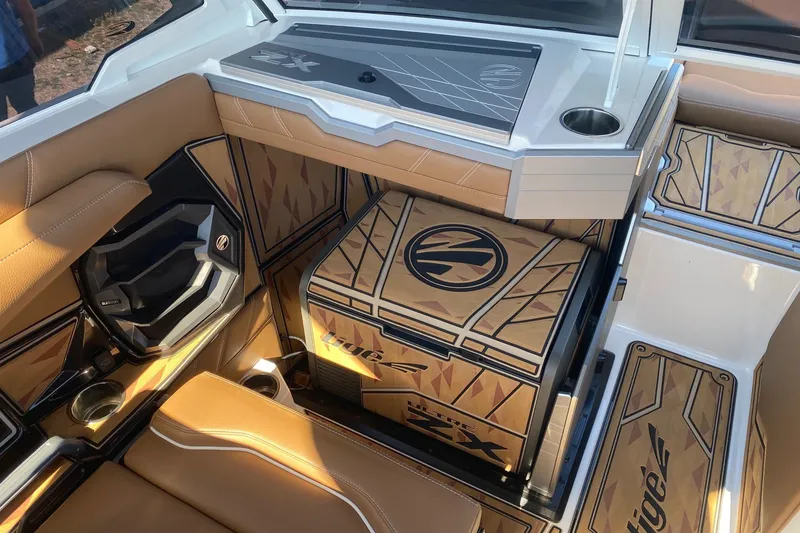 Slide: The Image of 2025 Tigé Ultré 25ZX boat interior with tan seating and custom design accents. - 7