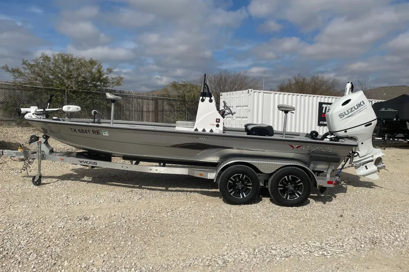 The Image of 2025 Vexus ACX2000 boat with Suzuki engine on trailer, parked outdoors. - 1