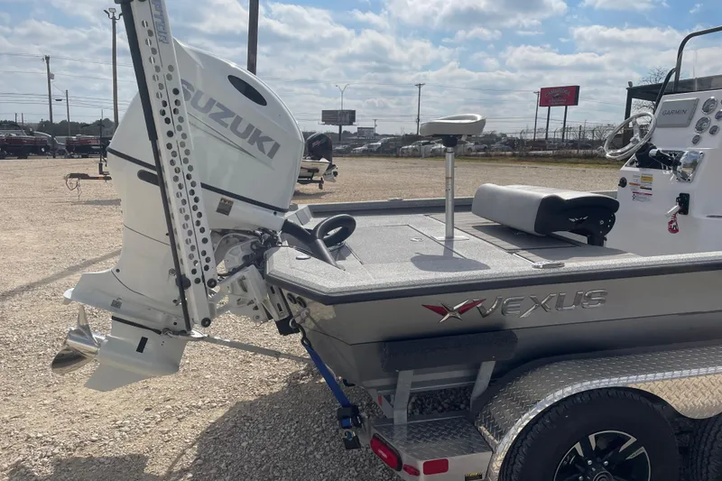 Slide: The Image of 2025 Vexus ACX2000 boat with Suzuki outboard motor in a sunny outdoor setting. - 4