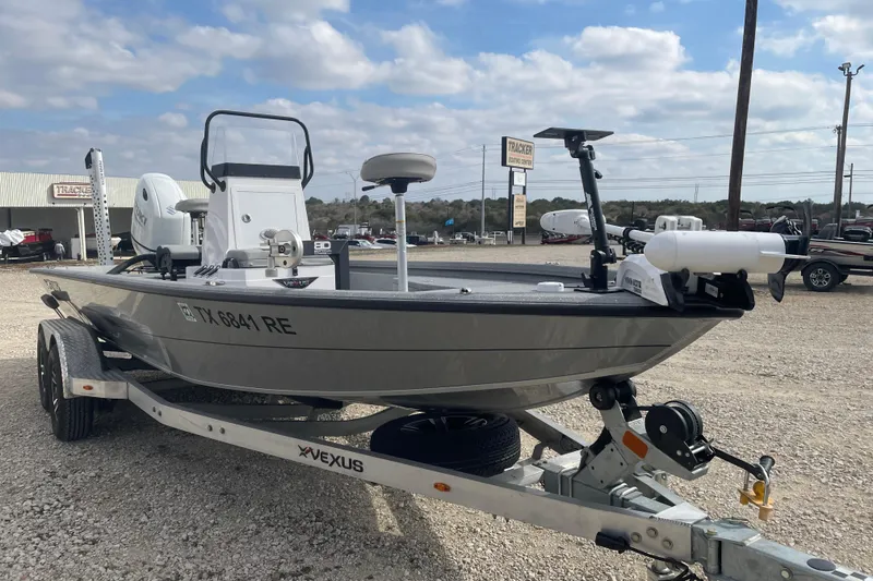 Slide: The Image of 2025 Vexus ACX2000 boat on trailer, parked outdoors under cloudy sky. - 6
