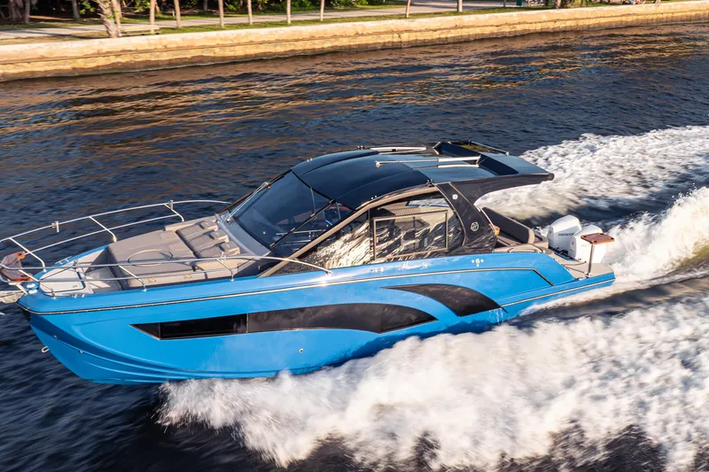 Slide: The Image of 2026 Hanover 347 boat cruising on water, showcasing sleek blue design and modern features. - 4