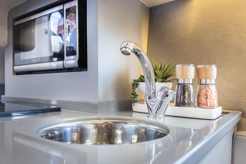 Slide: The Image of Modern kitchen in Hanover 347, 2026 model, featuring sink, microwave, and spice set. - 44