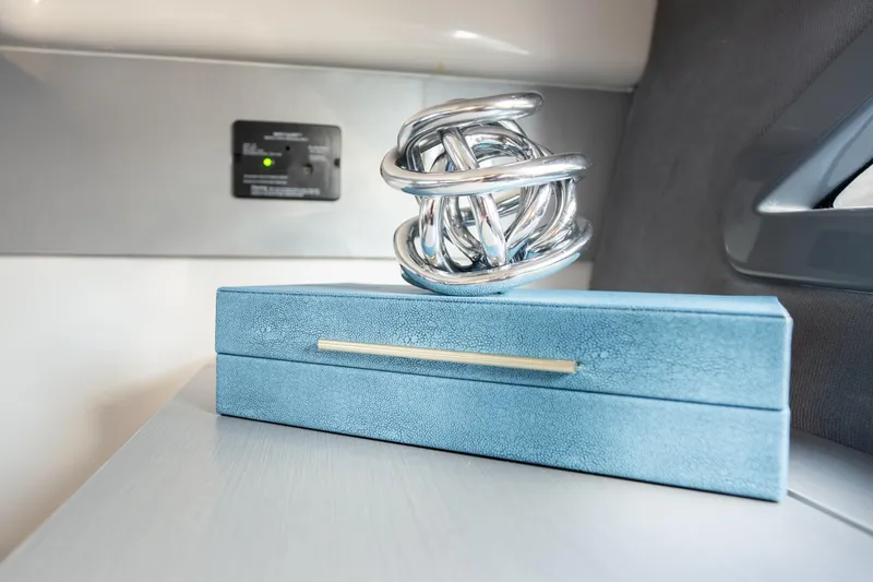 Slide: The Image of Silver sculpture on blue box inside Hanover 347, 2026 model. - 49