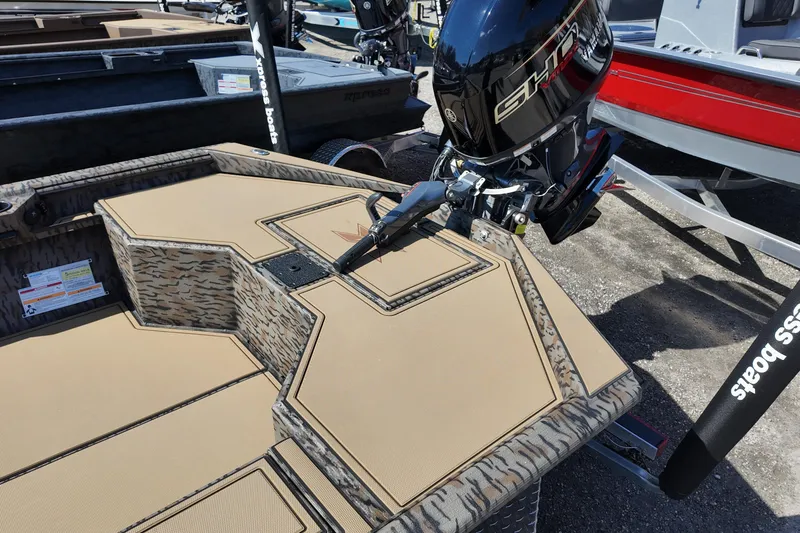 Slide: The Image of 2026 Xpress X18DB boat with camo design and powerful outboard motor. - 10