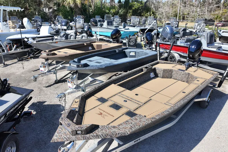 Slide: The Image of 2026 Xpress X18DB boats displayed in a dealership lot, featuring various colors and designs. - 11