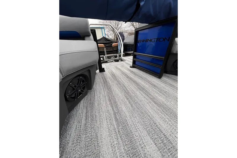 Slide: The Image of 2026 Bennington 22 M FASTBACK interior with stylish flooring and seating. - 10