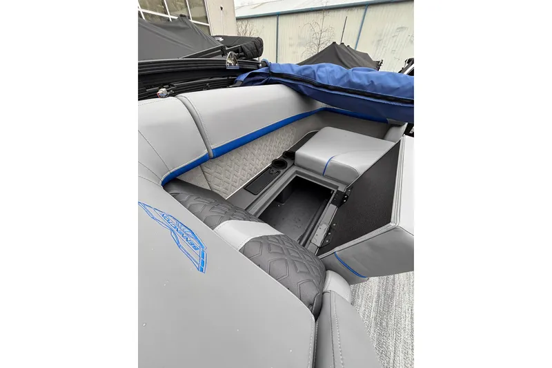 Slide: The Image of 2026 Bennington 22 M FASTBACK boat interior with gray and blue seating and storage compartment. - 12