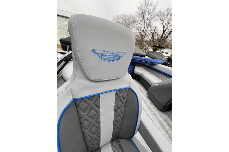 Slide: The Image of 2026 Bennington 22 M FASTBACK boat seat with logo, featuring gray and blue design. - 7