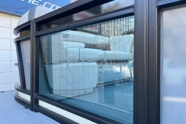 Slide: The Image of 2026 Godfrey Sweetwater 2086 SB pontoon boat with sleek glass railing and plush seating. - 5