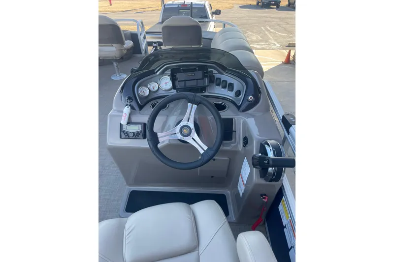 Slide: The Image of 2023 Sun Tracker Fishin' Barge 20 DLX dashboard with steering wheel and controls. - 3
