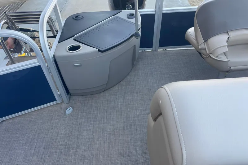 Slide: The Image of 2023 Sun Tracker Fishin' Barge 20 DLX interior with seating and storage area. - 4