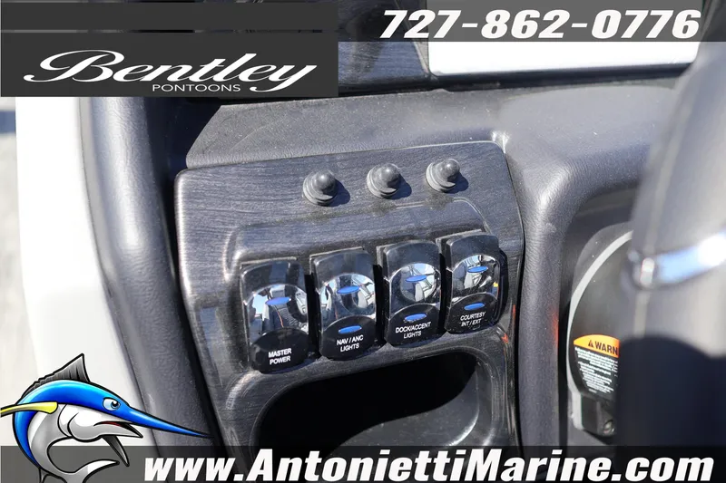 Slide: The Image of Control panel of 2026 Bentley Pontoons Elite 253 Swingback with switches and branding. - 25