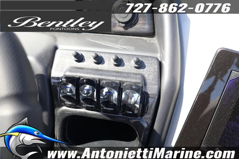 Slide: The Image of Control panel of 2026 Bentley Pontoons Elite 253 Swingback with switches and branding. - 27