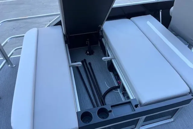 Slide: The Image of Open storage compartment in 2026 Godfrey EX 2286 SFLX boat with seating and cup holders. - 10