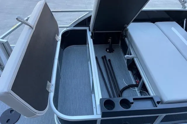 Slide: The Image of Open storage compartment in 2026 Godfrey EX 2286 SFLX boat with seating and cup holders. - 11