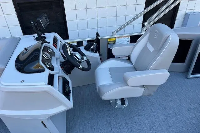 Slide: The Image of Captain's seat and helm of 2026 Godfrey EX 2286 SFLX boat. - 14