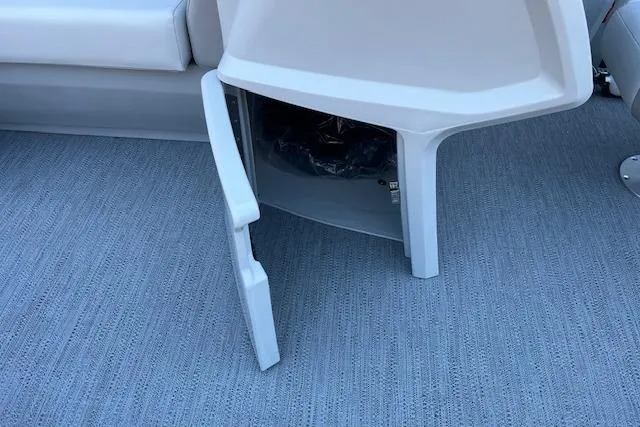 Slide: The Image of Open storage compartment on 2026 Godfrey EX 2286 SFLX boat, featuring gray interior. - 15