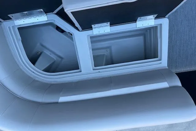 Slide: The Image of Interior storage compartment of 2026 Godfrey EX 2286 SFLX boat, featuring cushioned seating. - 17