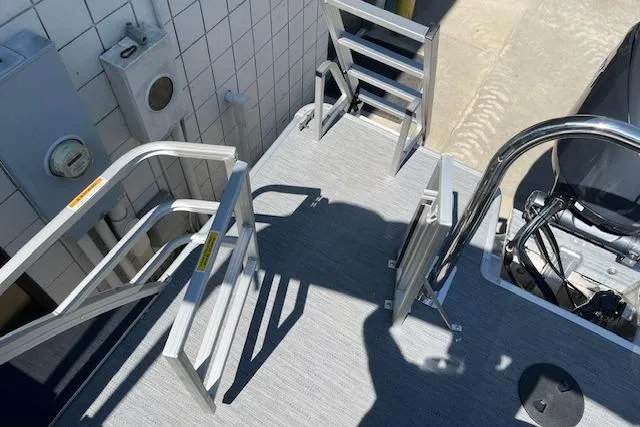 Slide: The Image of Aluminum deck of 2026 Godfrey EX 2286 SFLX boat with ladder and railing. - 20