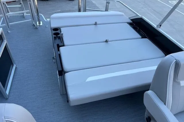 Slide: The Image of 2026 Godfrey EX 2286 SFLX boat interior with convertible seating and cup holders. - 9