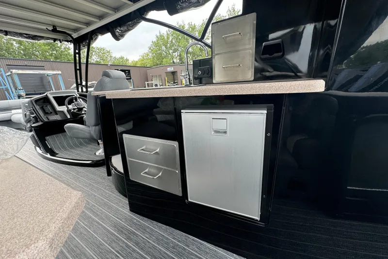 Slide: The Image of 2026 Premier Escalante boat interior with sleek black cabinetry and modern seating. - 16