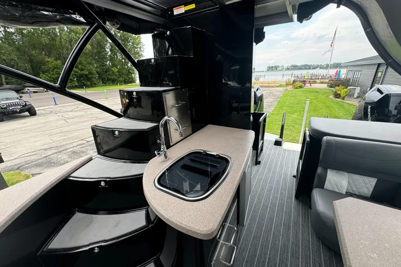 Slide: The Image of Luxurious 2026 Premier Escalante boat interior with kitchenette and seating, dockside view. - 18