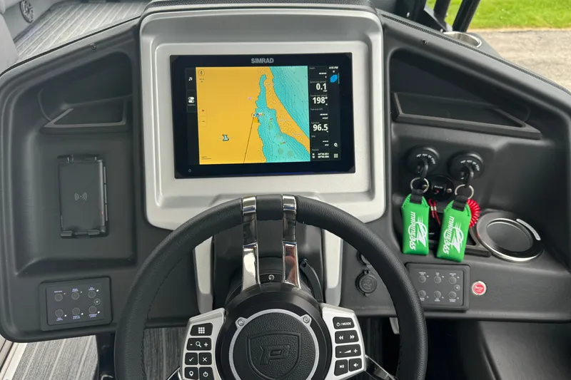 Slide: The Image of 2026 Premier Escalante boat dashboard with navigation display and steering wheel. - 21