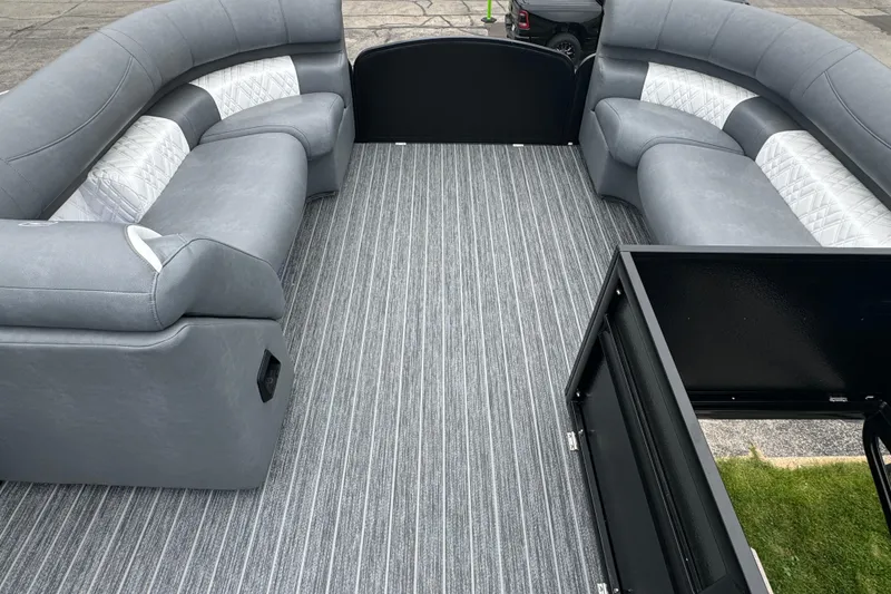 Slide: The Image of Luxurious interior of 2026 Premier Escalante pontoon boat with gray seating and striped flooring. - 38