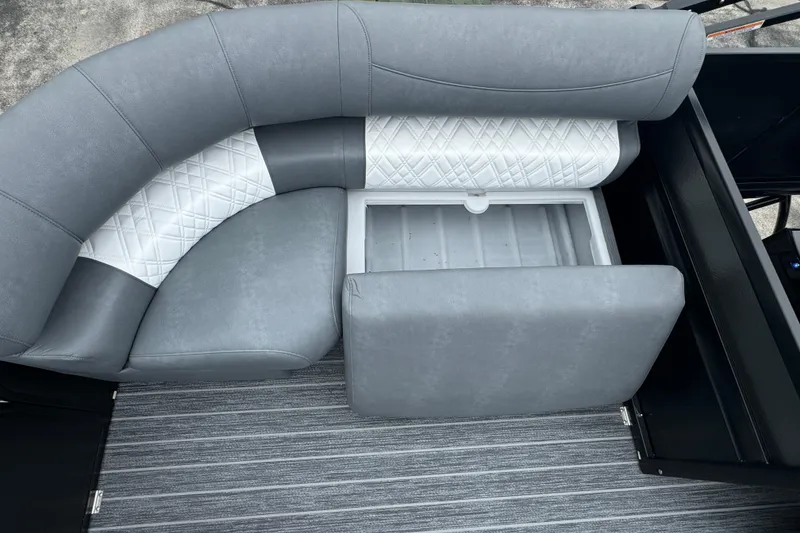 Slide: The Image of 2026 Premier Escalante boat seating with storage compartment, featuring gray and white upholstery. - 42
