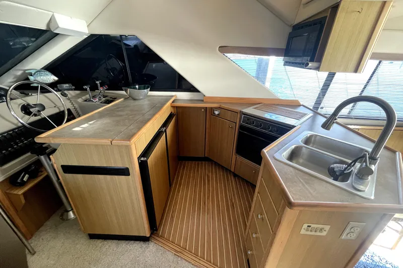 Slide: The Image of Interior of 2001 Bayliner 3988 Command Bridge Motoryacht with kitchen and helm station. - 11